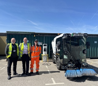 Cllr Peter Harvey, Michael Roberts, Transport and Vehicle Maintenance Manager and another Council worker who is part of the Operational In-House Services team at Sefton Council with electrical sweeper