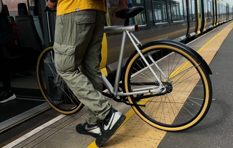 A bike being pushed onto a merseyrail train
