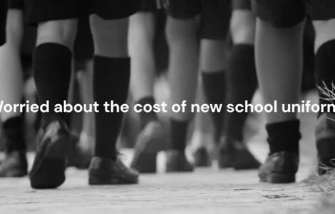 Black and white image image of  school children's feet and shoes walking away with the caption - worried about the cost of new school uniforms?