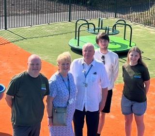 Councillors and staff standing in the Alt Road Park play area.