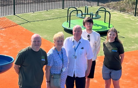 Councillors and staff standing in the Alt Road Park play area.