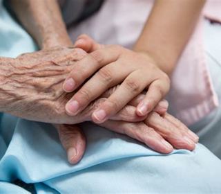 Younger and older persons' hands holding