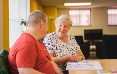 Two people looking at each other at a Carers Centre