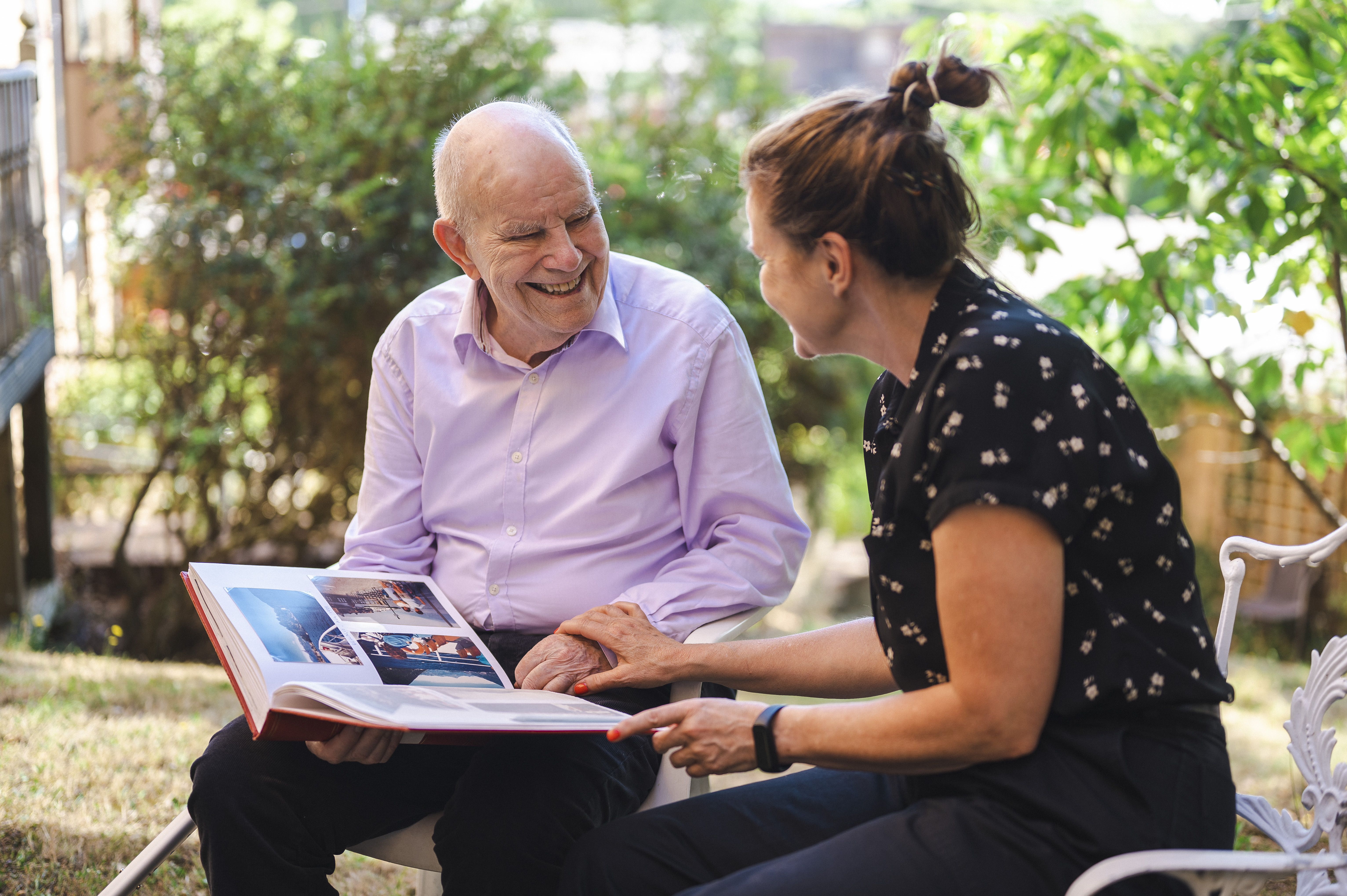 Two people looking at a photograph book