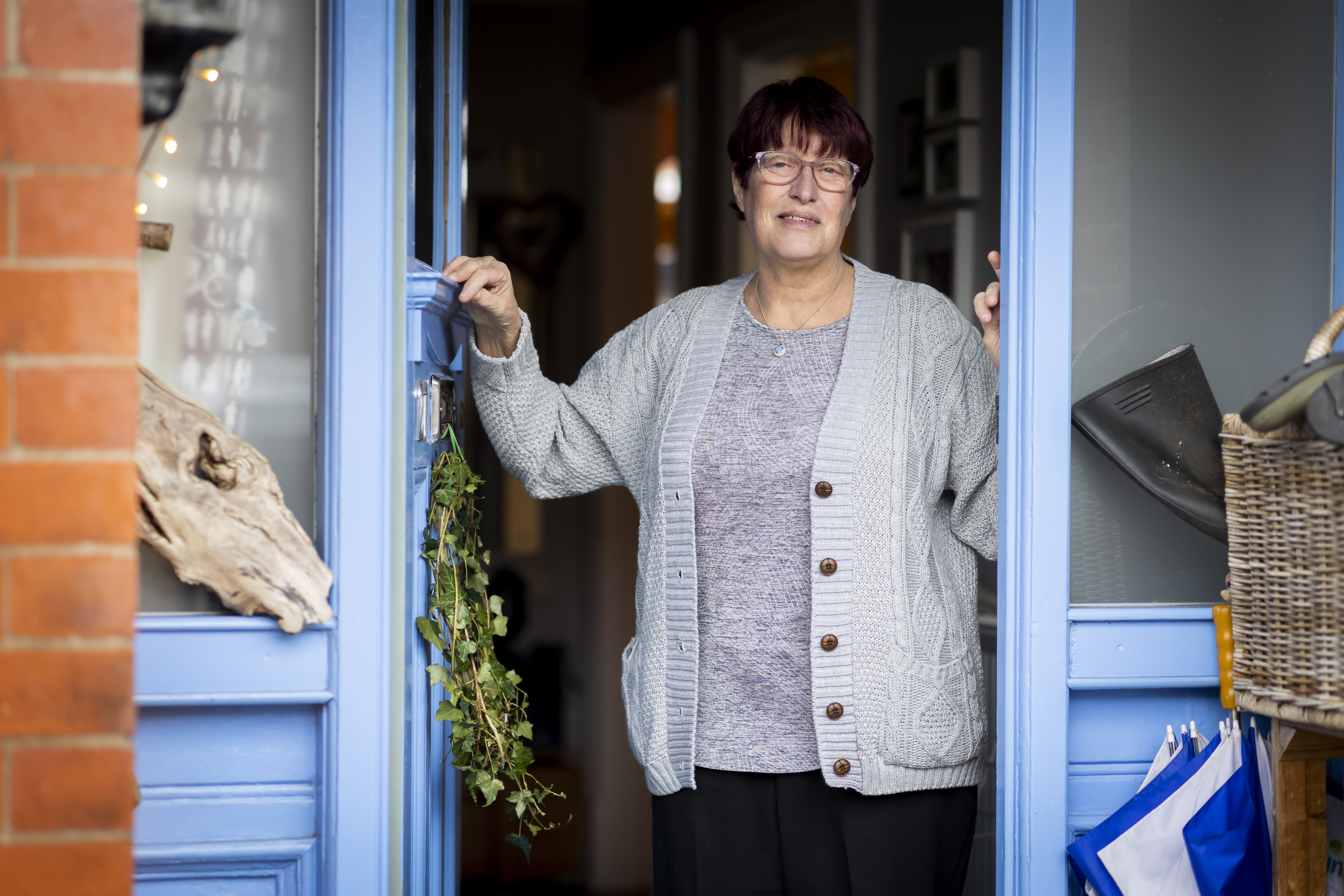 Woman standing in doorway of her home