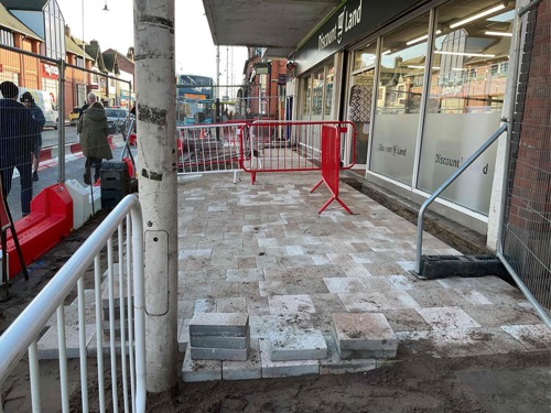 A progress picture of new paving slabs behind fencing next to Discount Land on Eastbank Street - January 2025