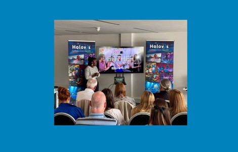 Someone making a presentation to an audience at a Sefton Huddle event